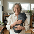 Woman holding a jarixo 3 in 1 back massager in a living room setting