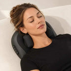 Cordless shiatsu neck massager in black with a contoured plastic body, padded kneading nodes and side controls