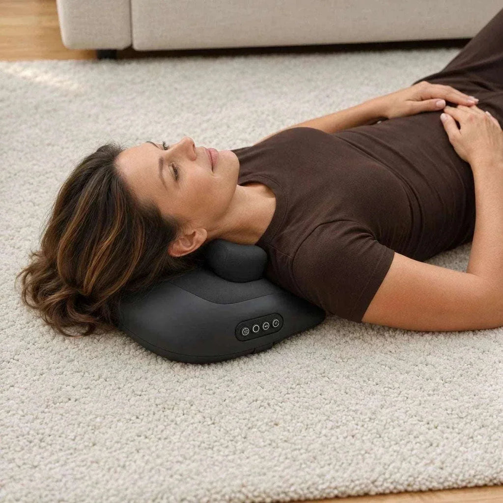 cordless shiatsu neck massager in black plastic with a padded cushion, rounded massage node and four-button control panel