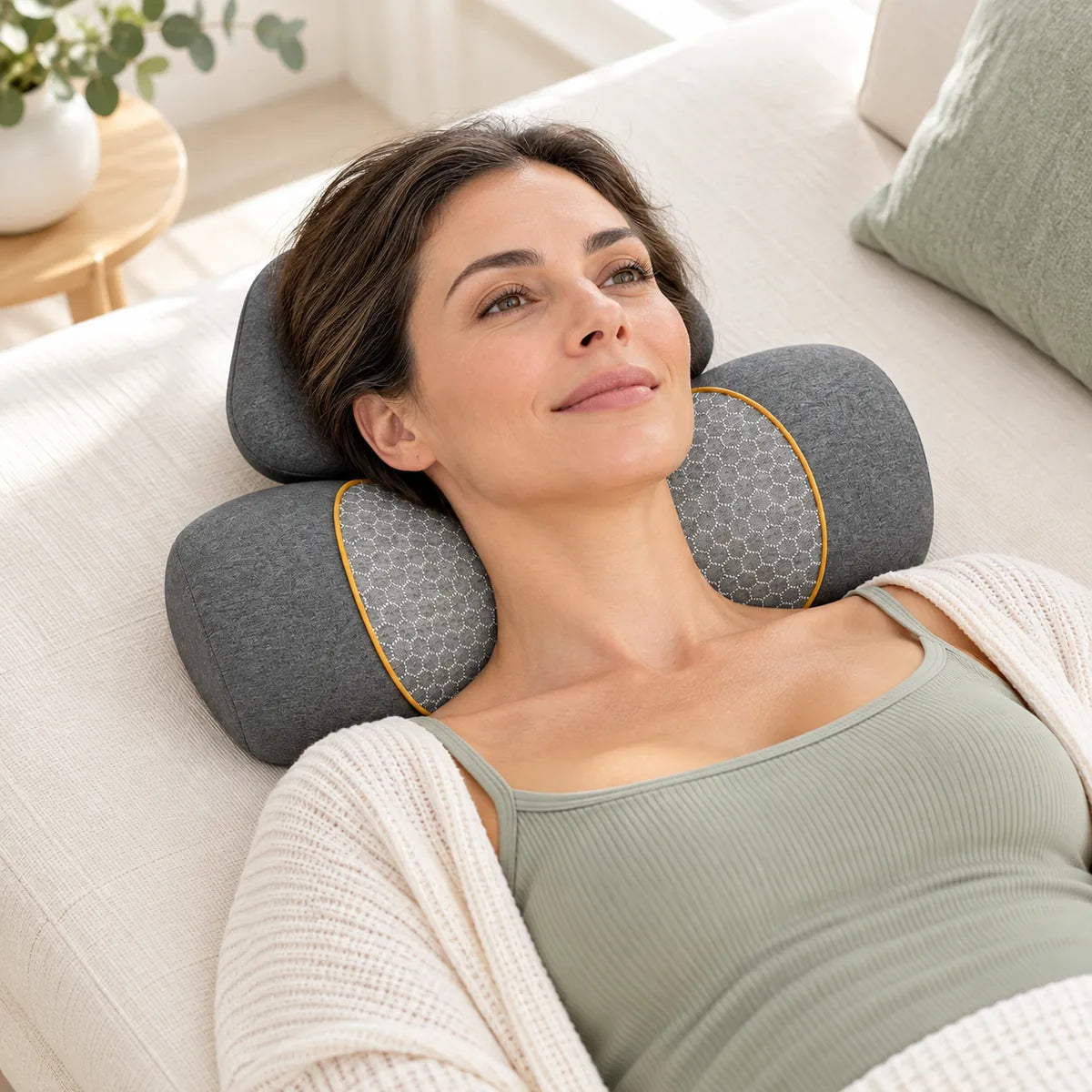Illustrative product lifestyle scene showing an awake woman resting with the grey Jarixo neck pillow.