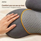 neck massager pillow in charcoal grey textured fabric with a mesh panel, orange piping and curved contours