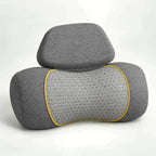 neck massager pillow in charcoal grey fabric with a honeycomb-patterned center panel, yellow trim and removable headrest